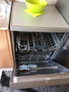 an open dishwasher with a bowl on top of it at Apartment Smestaj B in Novi Pazar