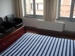 Postel nebo postele na pokoji v ubytování Guesthouse Oude Houtmarkt