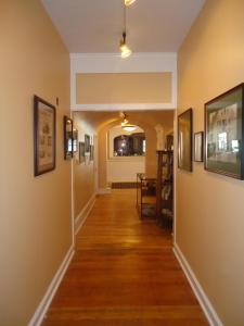 a hallway in a home with paintings on the walls at Thayers Inn in Littleton