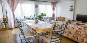 uma mesa de jantar e cadeiras numa sala de estar em Silvia's Apartment em Voluntari