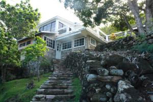 a stone path leading to a house with a stone wall at Posada Rock-stone in Providencia
