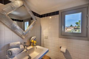 a bathroom with a sink and a mirror at Sweet Tuscany in Arezzo