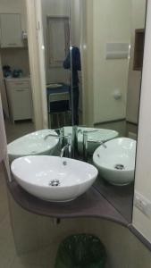 a bathroom with two sinks and a mirror at Casa Maddò in Castelbuono