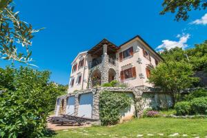 a house on a hill with a blue sky at Villa Marina in Veprinac