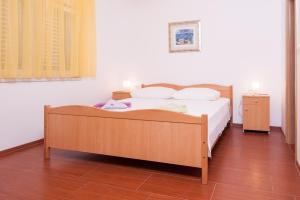 Postel nebo postele na pokoji v ubytování Apartmani Galija