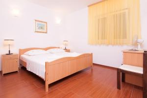 Postel nebo postele na pokoji v ubytování Apartmani Galija