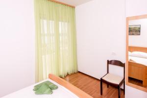 Postel nebo postele na pokoji v ubytování Apartmani Galija