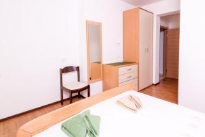 Postel nebo postele na pokoji v ubytování Apartmani Galija