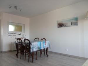 a dining room with a table and chairs at Orchidée in Berck-sur-Mer +23 photos