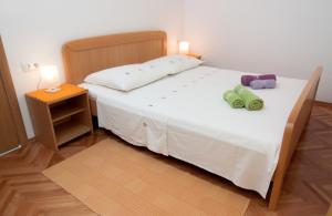 Postel nebo postele na pokoji v ubytování Apartmani Galija