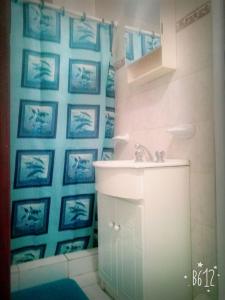 a bathroom with a sink and blue pictures on the wall at total servicios in Ciudad Lujan de Cuyo