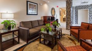 a living room with a couch and a table at Best Western Airport Inn & Suites Cleveland in Brook Park