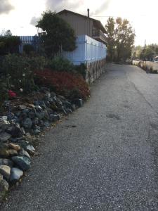 an empty street with rocks and a fence at Holiday Lodge in Grass Valley