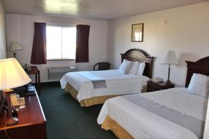 a hotel room with two beds and a window at Scipio Hotel in Scipio