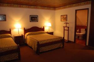 A bed or beds in a room at Posada Fueguina