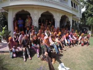 a group of people posing for a picture in front of a building at Krishna Palace - A Heritage Hotel in Jaipur