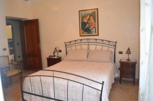 een slaapkamer met een bed en een foto aan de muur bij House at the Beach in Ladispoli just the north of Rome in Ladispoli