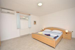 Postel nebo postele na pokoji v ubytování Apartments Mara