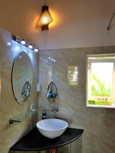 a bathroom with a sink and a mirror at Hung Vuong Resort in Phu Quoc