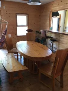a dining room with a wooden table and chairs at Guesthouse Irago in Tahara