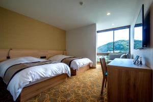 Кровать или кровати в номере Lectore Atami Koarashi - TKP Hotels & Resorts