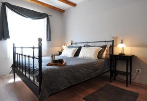 a bedroom with a black bed and a window at Villa Bilen in Medulin +15 photos