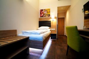 a hotel room with a bed and a piano at Hotel Marc Aurel - Vienna City Center in Vienna