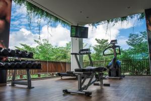 a gym with two tread machines and a large window at Anantara Uluwatu Bali Resort in Uluwatu