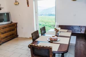a dining room with a table with a cake on it at Chalupa Na Žofíně in Horní Podluží