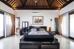 a bedroom with a large bed in a room at Villa L'Orange Bali in Keramas +100 photos