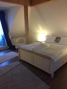 a bedroom with a white bed with a window at Schwedenfrieden in Bielefeld