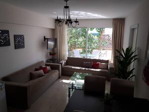 a living room with a couch and a table at Marianna Hotel Apartments in Limassol