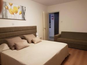 a bedroom with a large bed and a couch at Marianna Hotel Apartments in Limassol