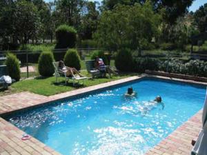 a group of people swimming in a swimming pool at Aristocrat Waurnvale in Geelong