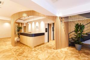 an office lobby with a reception desk and a staircase at R Star Hostel Kyoto in Kyoto