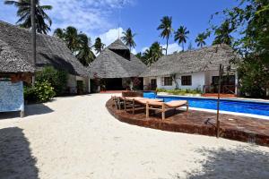 a resort with a swimming pool and some buildings at Sea View Lodge Boutique Hotel in Jambiani