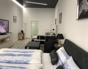 a room with a couch and a living room with a tv at Am Brand in Mainz