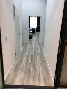 a hallway of an apartment with white walls and wood floors at Am Brand in Mainz