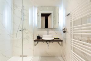 a bathroom with a sink and a shower at Abieshomes Serviced Apartments - Votivpark in Vienna