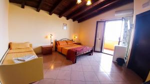 a bedroom with two beds and a large window at Villa Jolanda & Carmelo in Villaggio Mosè