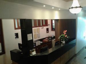 a kitchen with a large mirror and a counter top at Hotel São Bento in Belo Horizonte