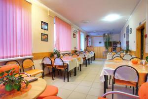 a row of tables and chairs in a restaurant at Guest House Lisya Nora in Psebay