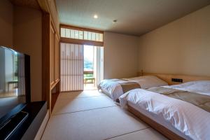 Кровать или кровати в номере Lectore Atami Koarashi - TKP Hotels & Resorts