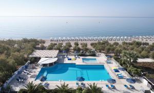 an aerial view of a resort with a pool and beach at Kouros Seasight Hotel in Pythagoreio
