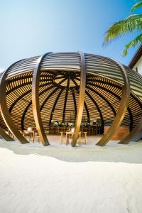 a large wooden bench sitting on the beach at Anantara Peace Haven Tangalle Resort in Tangalle