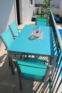 a blue table and chairs on a balcony at Olive View in Vila Nova da Barquinha