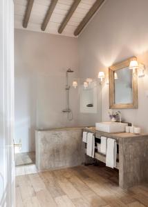 a bathroom with a sink and a mirror at Quinta da Chaminé in Ferreira do Alentejo