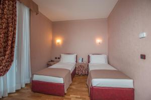 Postel nebo postele na pokoji v ubytování SIRIOHotel