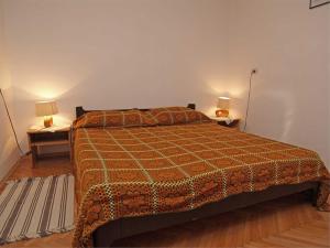 a bedroom with a bed with two night stands and two lamps at Anastasia 1 in Veli Lošinj