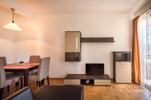 a living room with a table and a dining room at Apartments Montreal in Budva